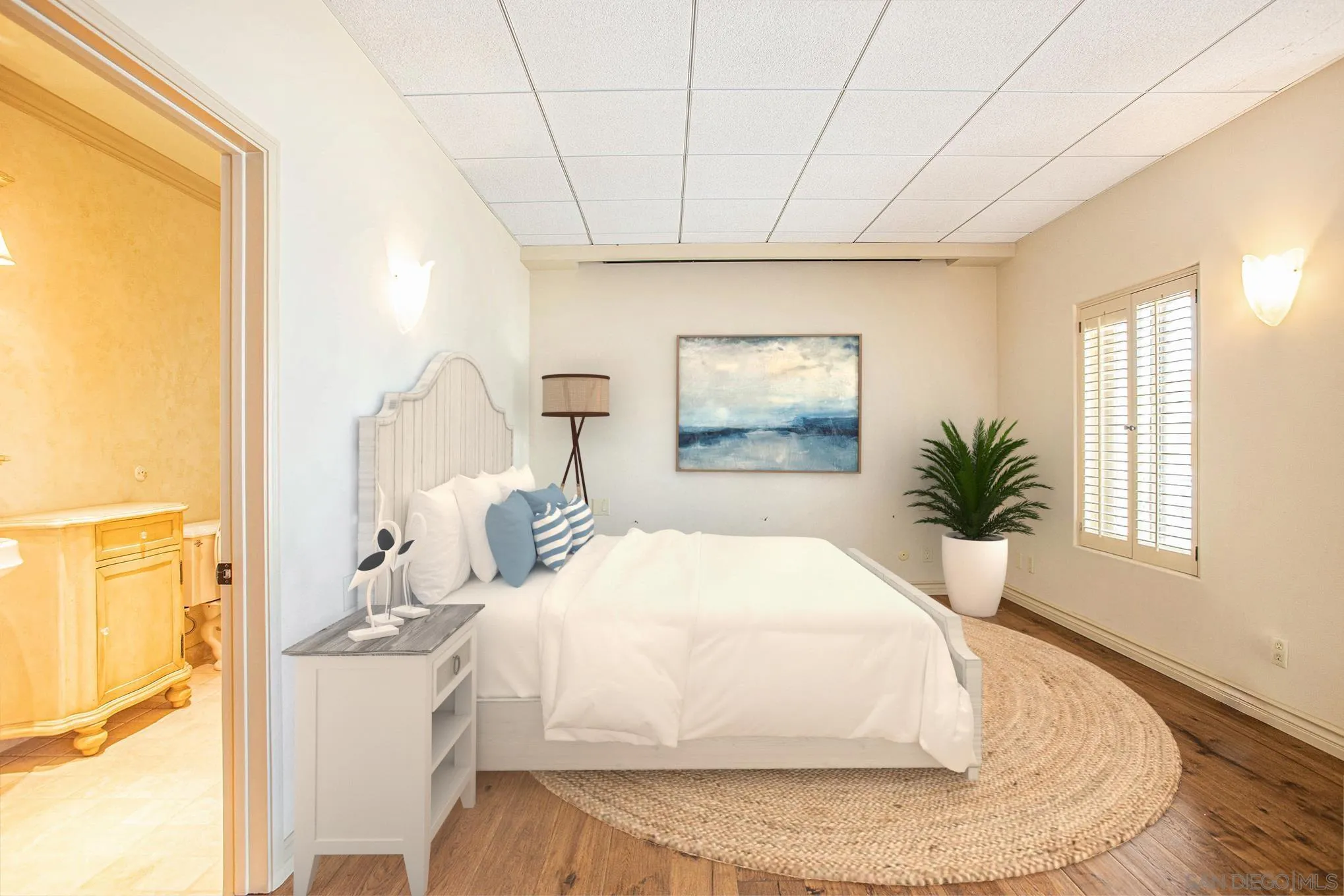 34 The Point Coronado, CA 92118 - Photo 24 of 71 a bedroom with a large bed and a chandelier