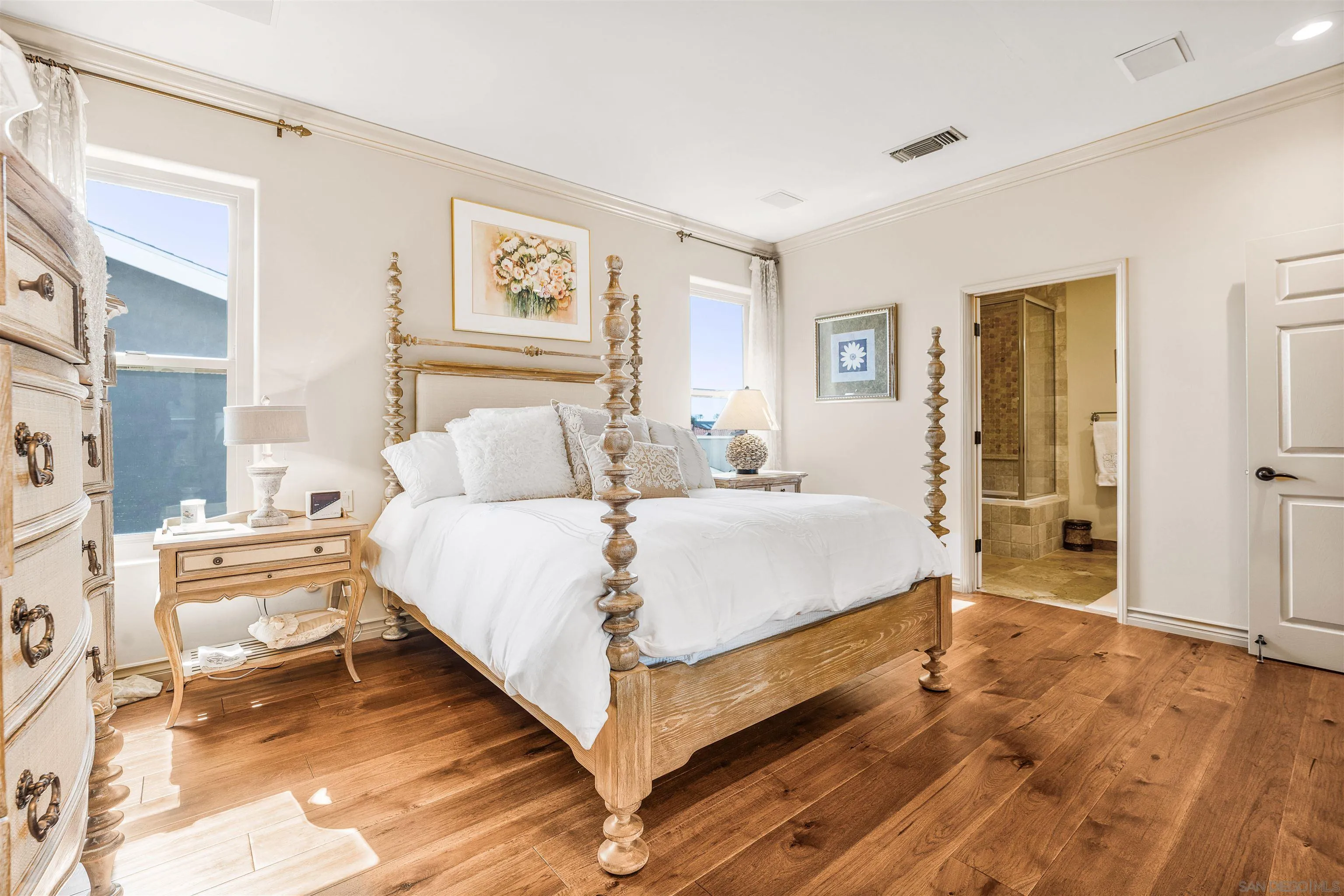 34 The Point Coronado, CA 92118 - Photo 30 of 71 a spacious bedroom with a bed and painting on the wall