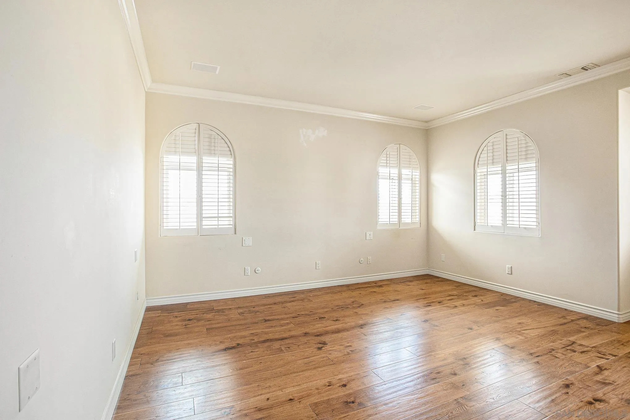 34 The Point Coronado, CA 92118 - Photo 35 of 71 an empty room with wooden floor and windows