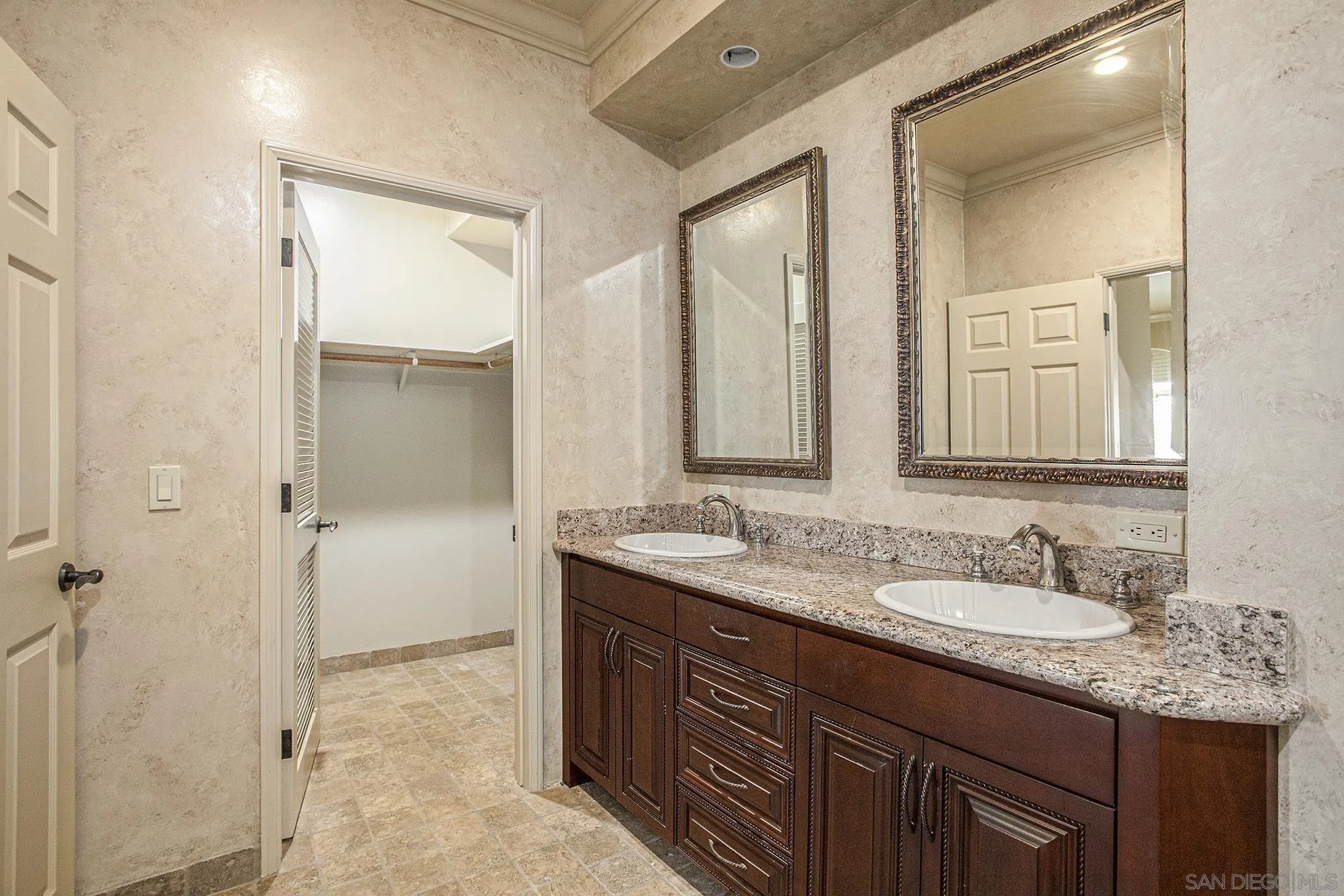 34 The Point Coronado, CA 92118 - Photo 38 of 71 a bathroom with a granite countertop sink mirror and a