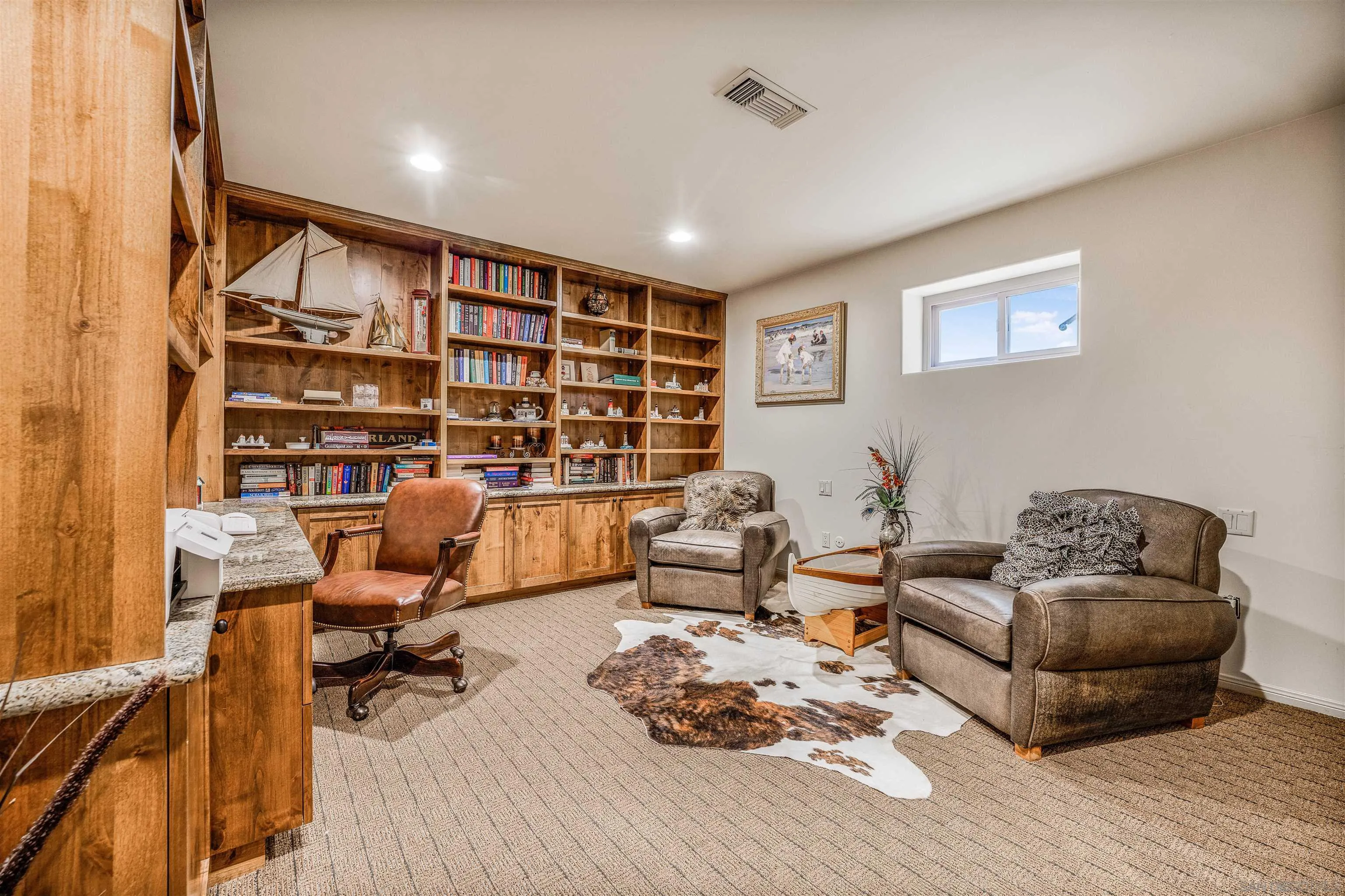 34 The Point Coronado, CA 92118 - Photo 54 of 71 a living room with furniture hard wood floor and a book shelf