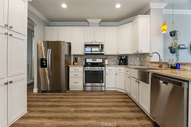 a kitchen with stainless steel appliances a stove a sink and a microwave