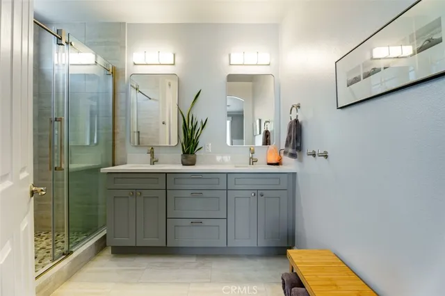 a bathroom with a sink a mirror and a shower