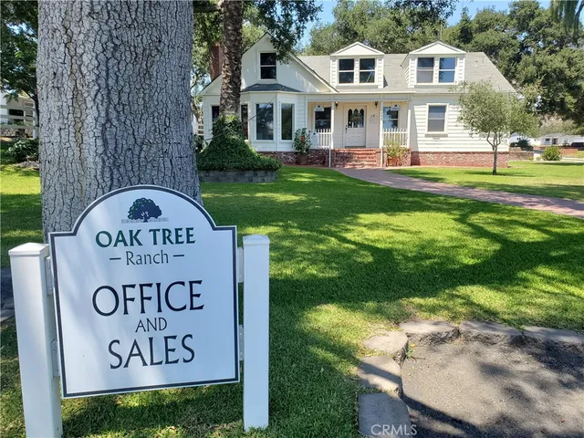 a front view of a house with garden and sitting area