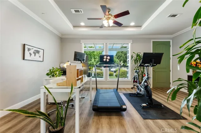 a kitchen with stainless steel appliances a dining table a stove top oven a refrigerator cabinets and dining table with wooden floor