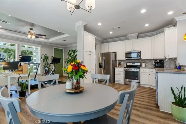 a kitchen with a refrigerator sink and cabinets