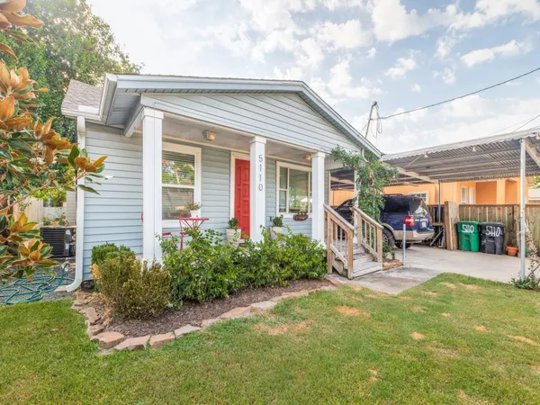 a view of a house with backyard porch and sitting area