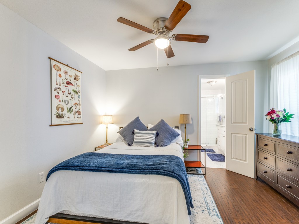 5110 Cochran Street Houston, TX 77009 - Photo 17 of 23 a bedroom with a bed chandelier and a window