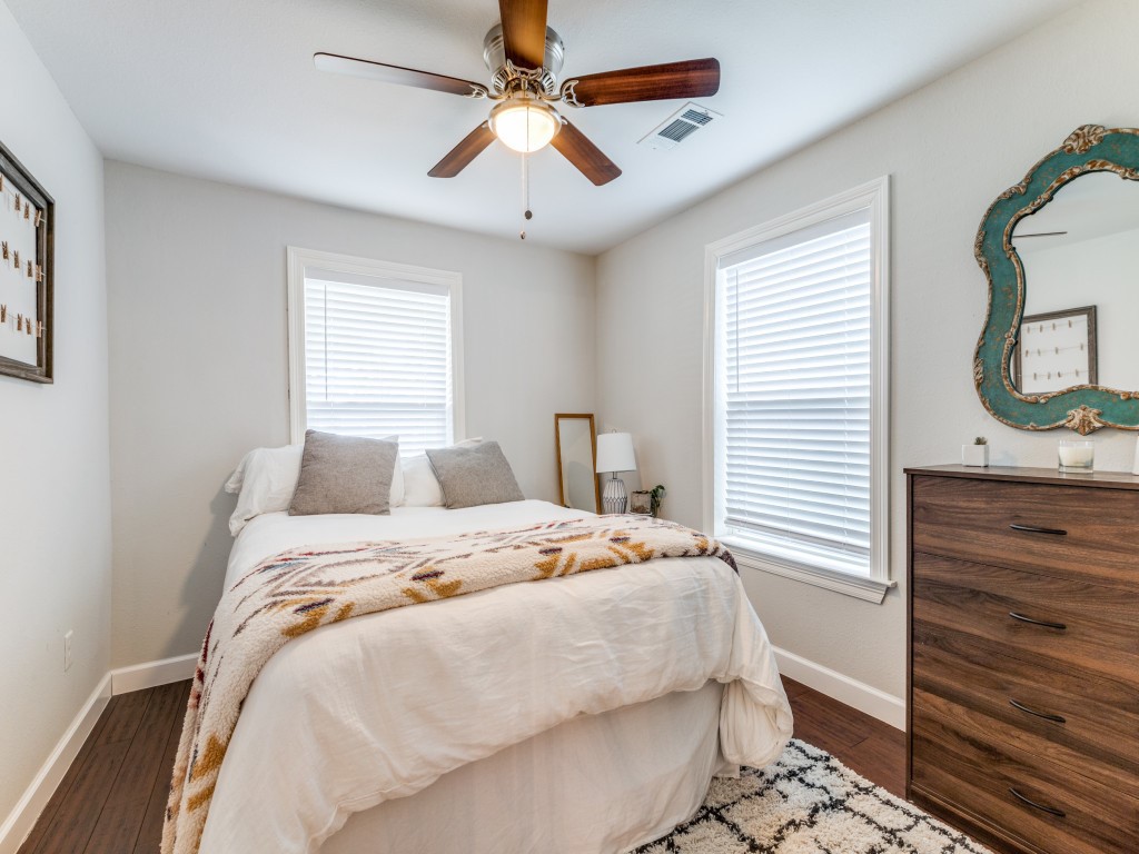 5110 Cochran Street Houston, TX 77009 - Photo 18 of 23 a bedroom with a bed a dresser and a window