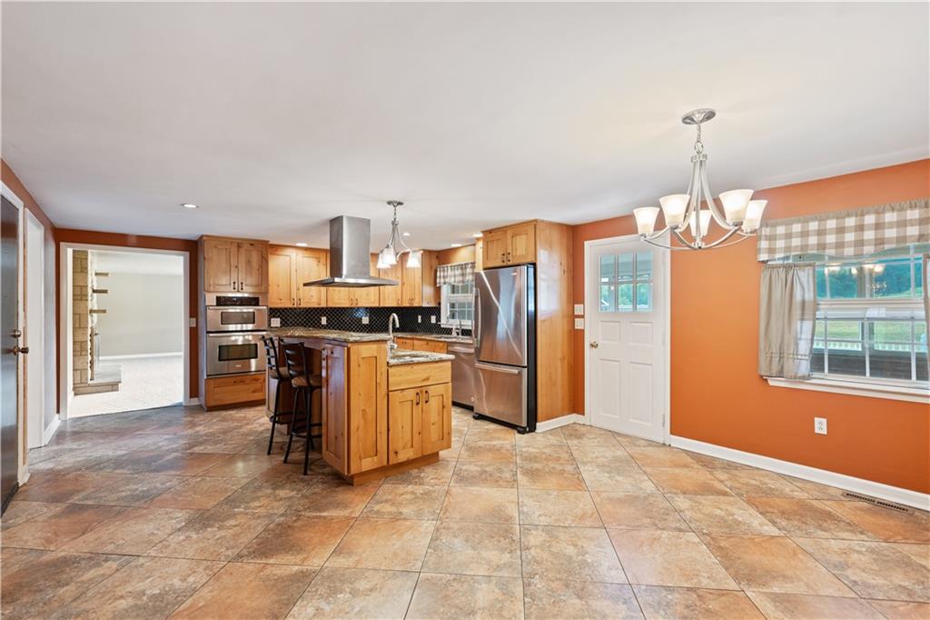 185 Reed Road Avella, PA 15312 - Photo 11 of 50 a kitchen with stainless steel appliances granite countertop a refrigerator and stove top oven