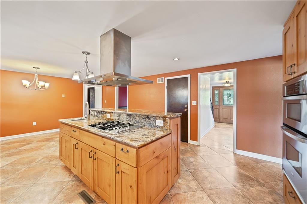 185 Reed Road Avella, PA 15312 - Photo 13 of 50 a kitchen with stainless steel appliances granite countertop a stove oven and a refrigerator