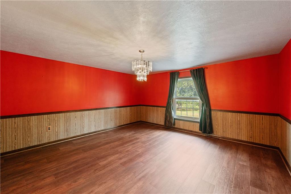185 Reed Road Avella, PA 15312 - Photo 15 of 50 a view of an empty room with wooden floor and a window