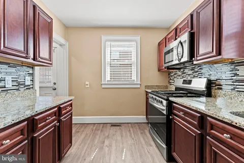 a kitchen with stainless steel appliances granite countertop a stove and a sink