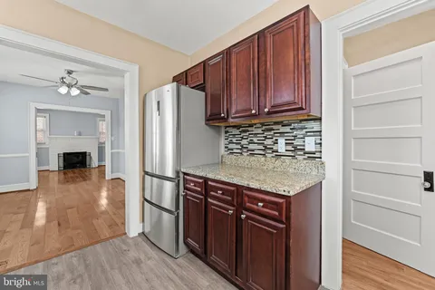 a kitchen with stainless steel appliances granite countertop a refrigerator and a stove top oven