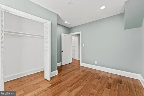an empty room with wooden floor