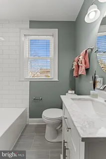 a bathroom with a sink a toilet and a bathtub