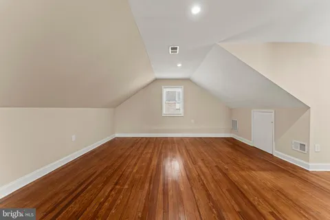 a view of an empty room and wooden floor