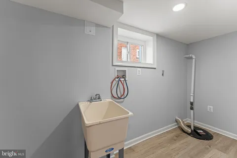 a bathroom with a granite countertop sink and a window