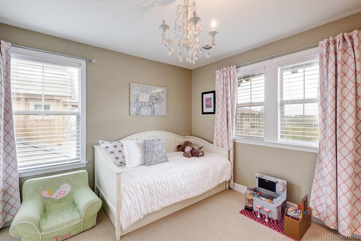 10711 Sundial Rim Road Highlands Ranch, CO 80126 - Photo 23 of 35 a bedroom with a bed and wooden floor
