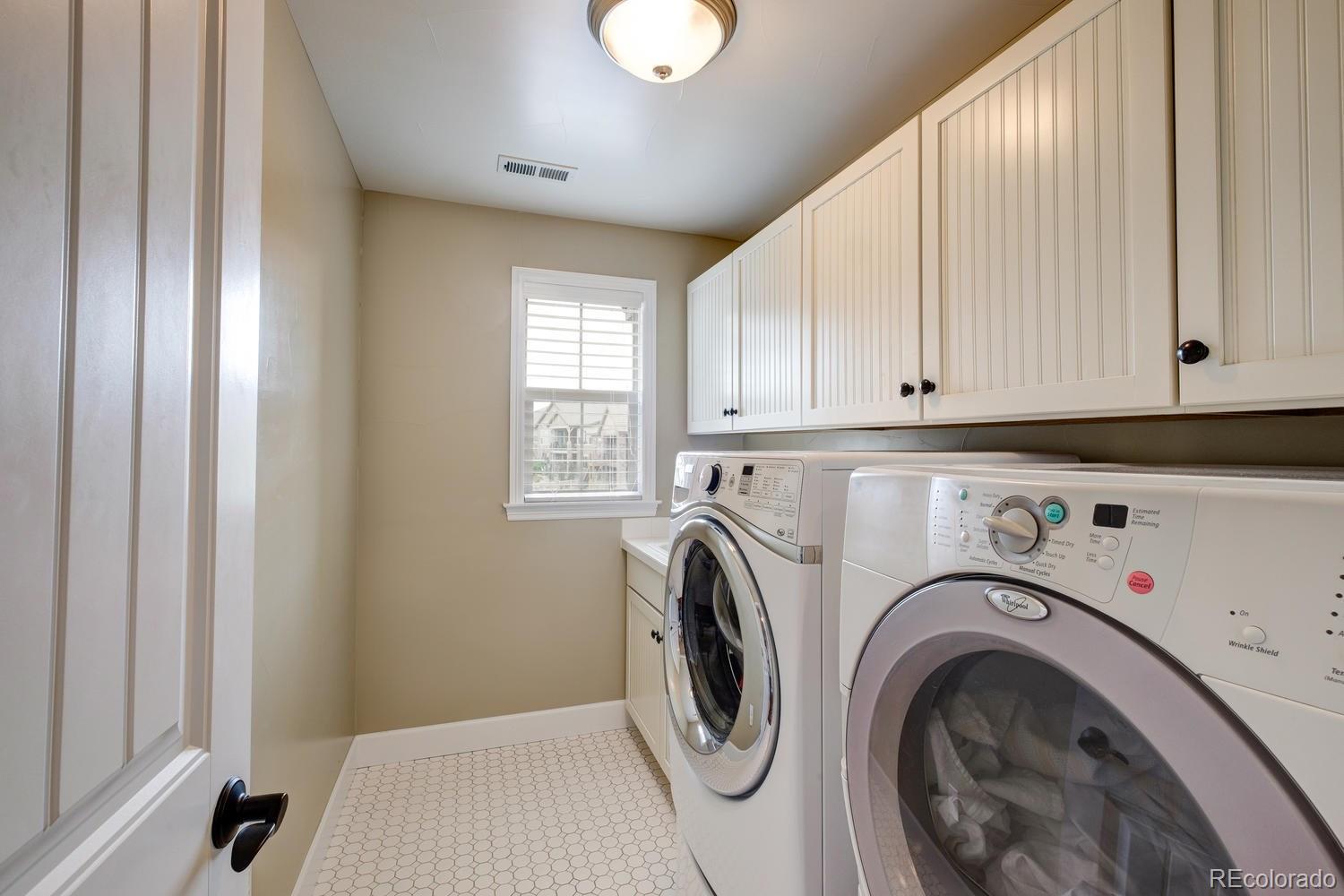 10711 Sundial Rim Road Highlands Ranch, CO 80126 - Photo 29 of 35 a utility room with dryer and washer