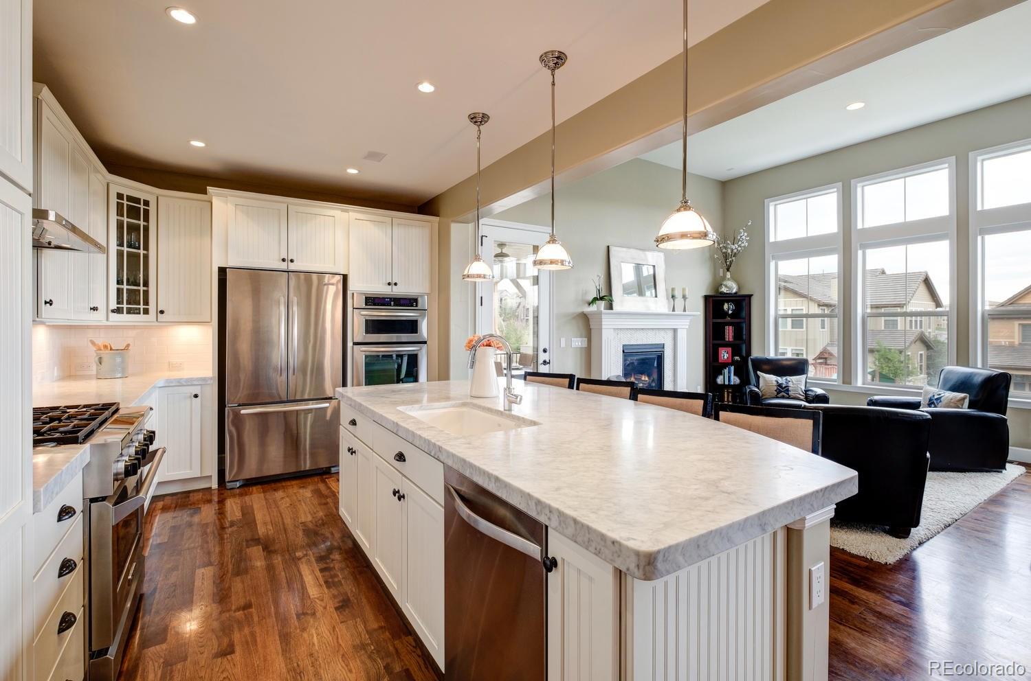 10711 Sundial Rim Road Highlands Ranch, CO 80126 - Photo 4 of 35 a kitchen with a center island appliances and cabinets