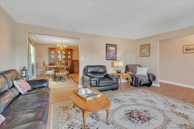 a living room with furniture a rug and a lamp