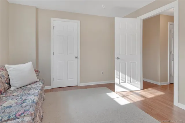 a view of a bedroom with wooden floor