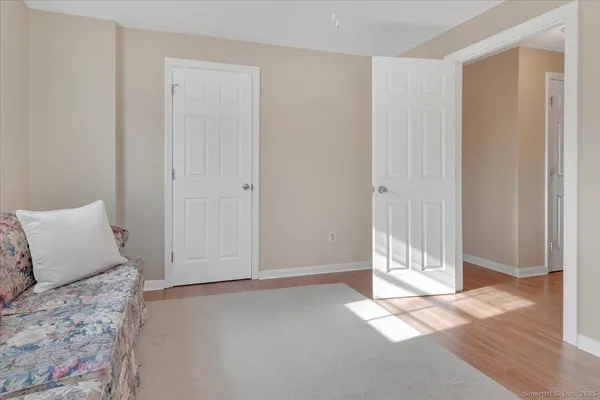 a view of a bedroom with wooden floor