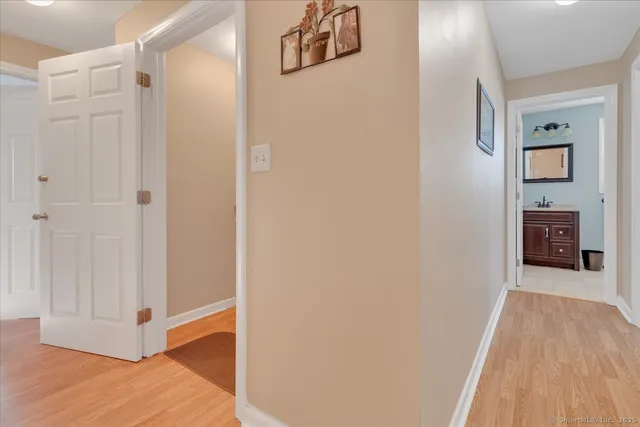 a view of a hallway view with wooden floor and staircase