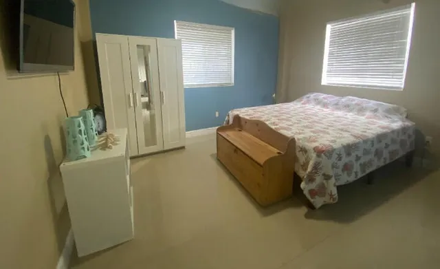 a bed sitting in a bedroom next to a window