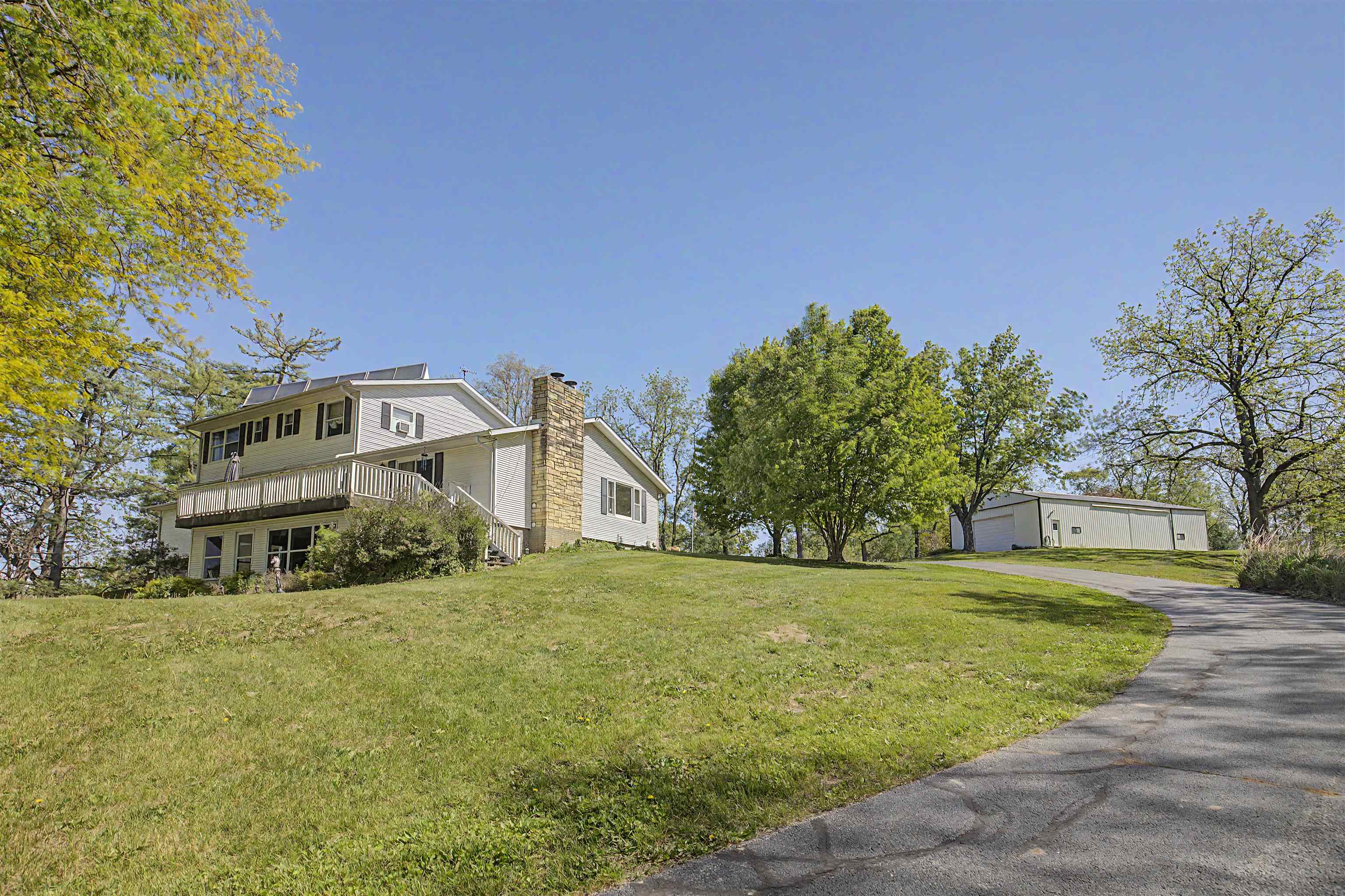 17380 Corbett Road Mount Carroll, IL 61053 - Photo 57 of 65 a view of a white house with a big yard and large trees