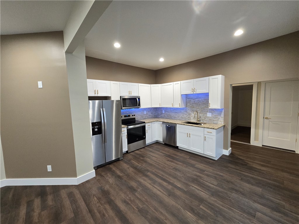 28 Ames Street Seneca, SC 29678 - Photo 11 of 22 Gleaming stone countertops and stainless steel appliances anchor this modern cooking space.
