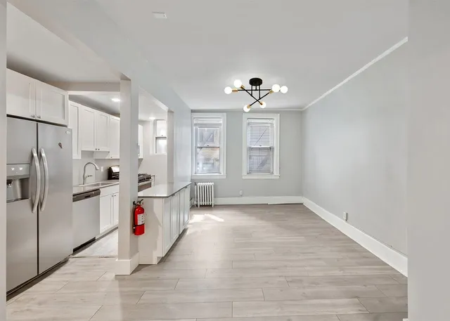 a view of a city street with a building and trees in the background