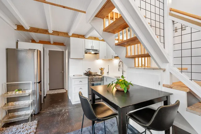 a kitchen with stainless steel appliances granite countertop a sink and a stove