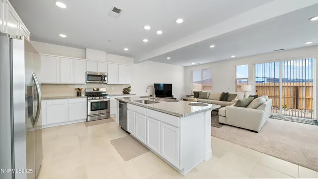 a kitchen with kitchen island white cabinets and refrigerator
