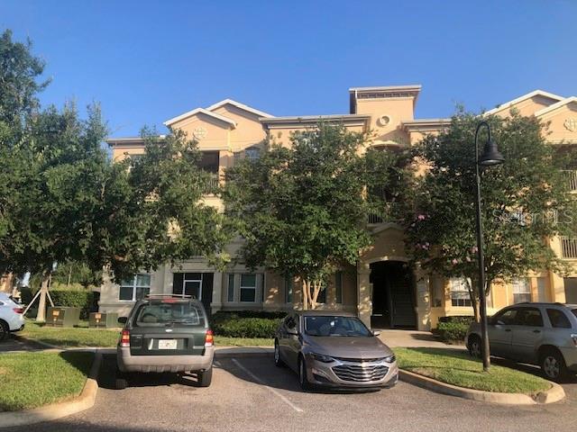 120 Terrace Ridge Circle, Unit 120 Davenport, FL 33896 - Photo 2 of 11 a car parked in front of a building