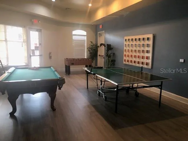 a living room with furniture a table and large window