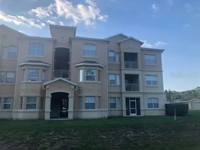 a view of a brick building next to a yard