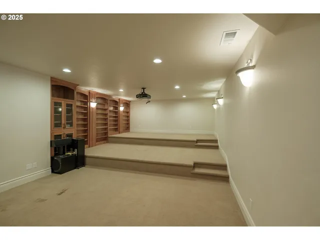 a view of a hallway with wooden floor and a cabinet