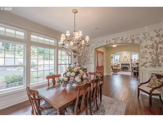 a view of a dining room with furniture wooden floor and chandelier