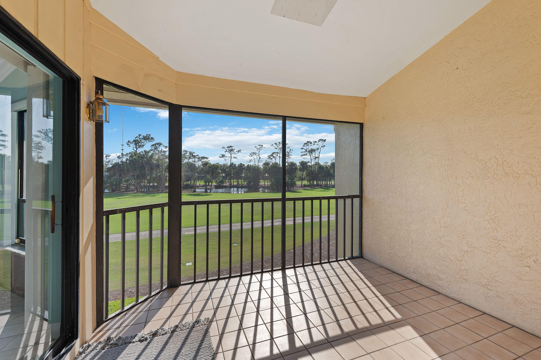 792 Eagle Creek Drive, Unit 204 Naples, FL 34113 - Photo 17 of 49 a view of a balcony with wooden floor