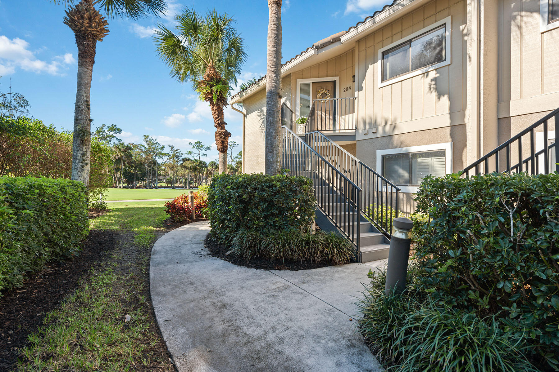 792 Eagle Creek Drive, Unit 204 Naples, FL 34113 - Photo 18 of 49 a view of a garden with a fountain
