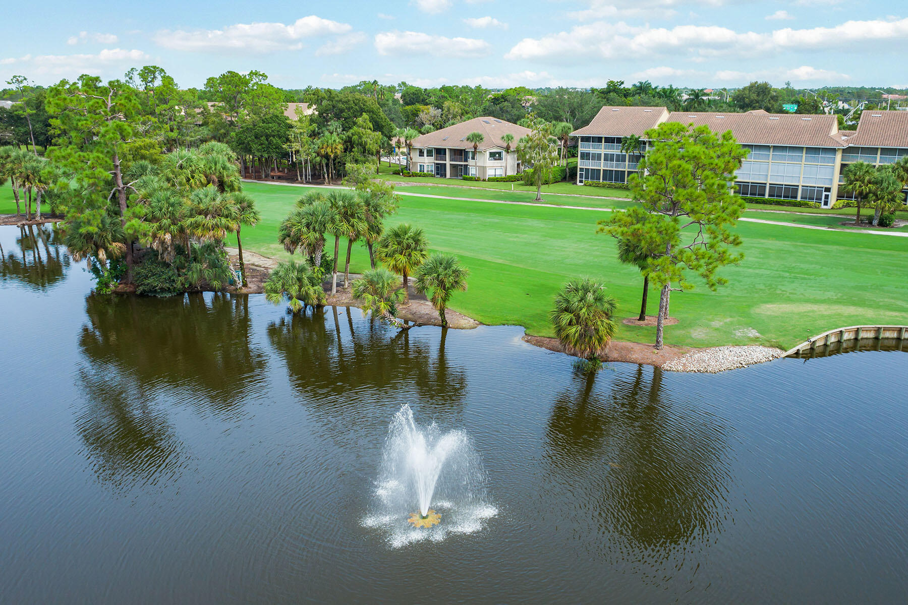 792 Eagle Creek Drive, Unit 204 Naples, FL 34113 - Photo 31 of 49 a view of a lake with a yard