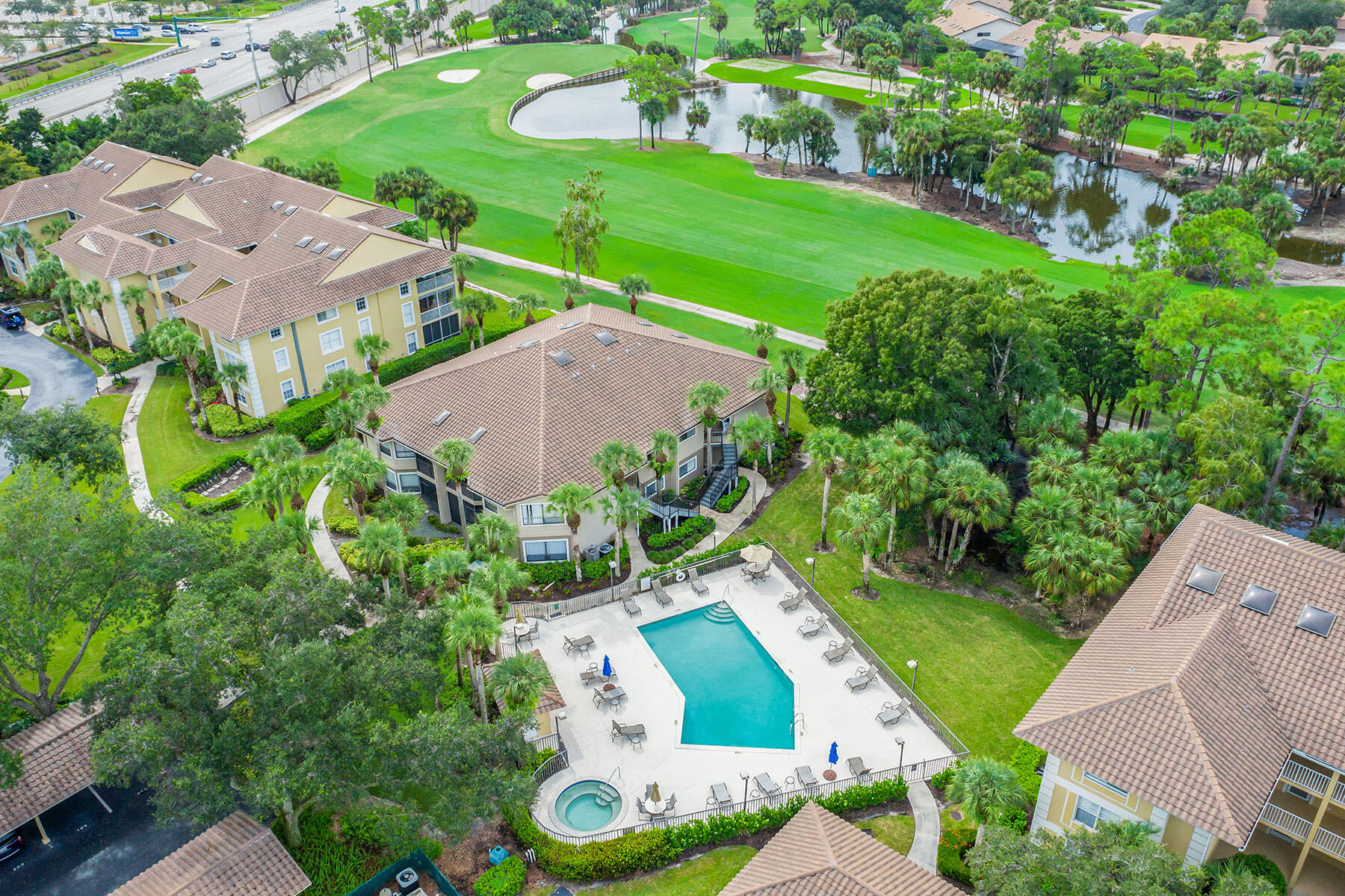 792 Eagle Creek Drive, Unit 204 Naples, FL 34113 - Photo 32 of 49 an aerial view of a house with garden space and street view