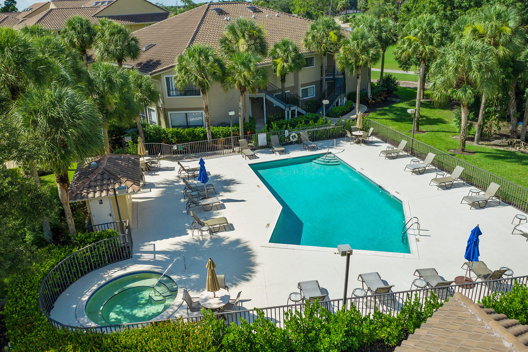 792 Eagle Creek Drive, Unit 204 Naples, FL 34113 - Photo 35 of 49 a swimming pool with outdoor seating and trees