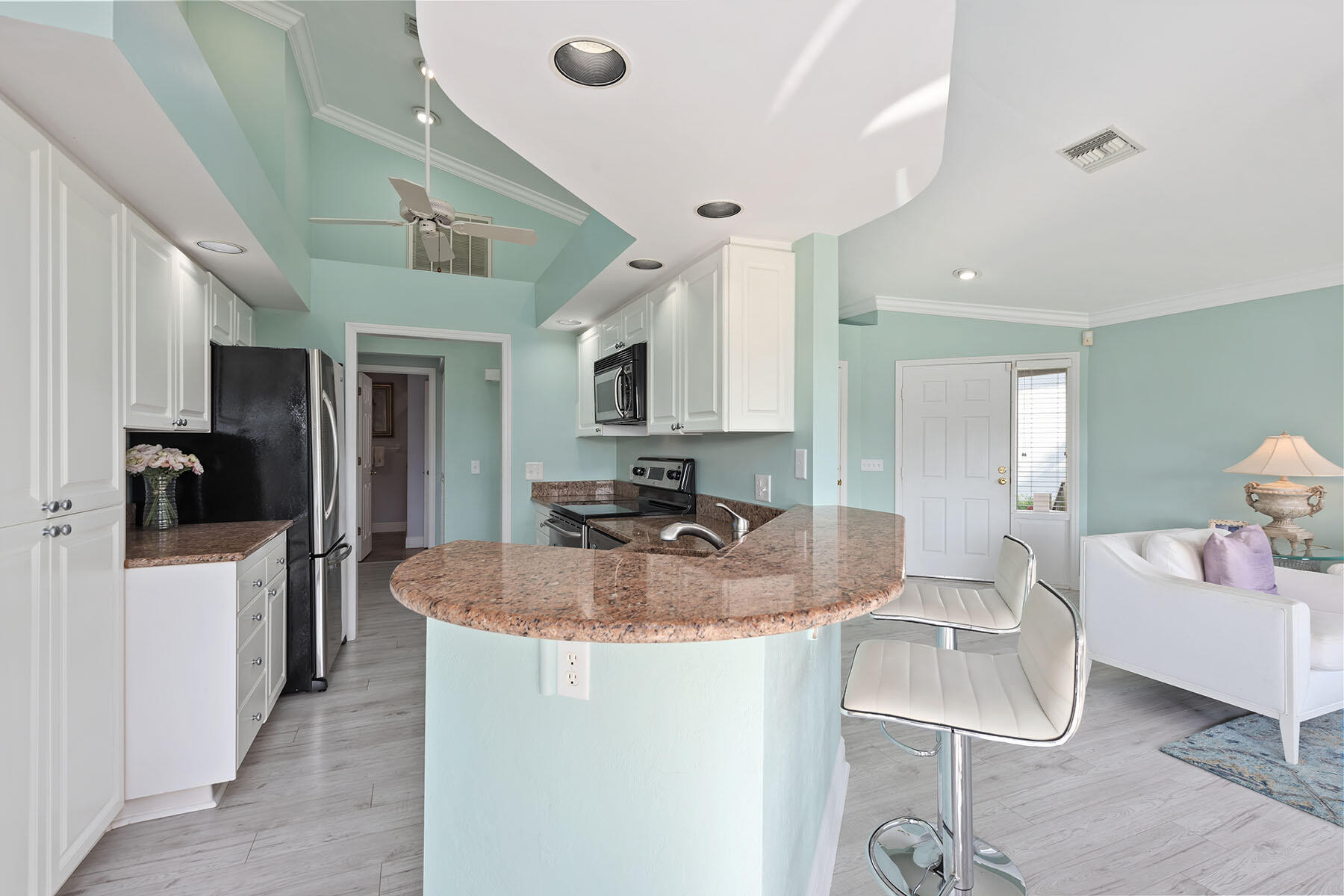 792 Eagle Creek Drive, Unit 204 Naples, FL 34113 - Photo 5 of 49 a kitchen with sink refrigerator and fireplace