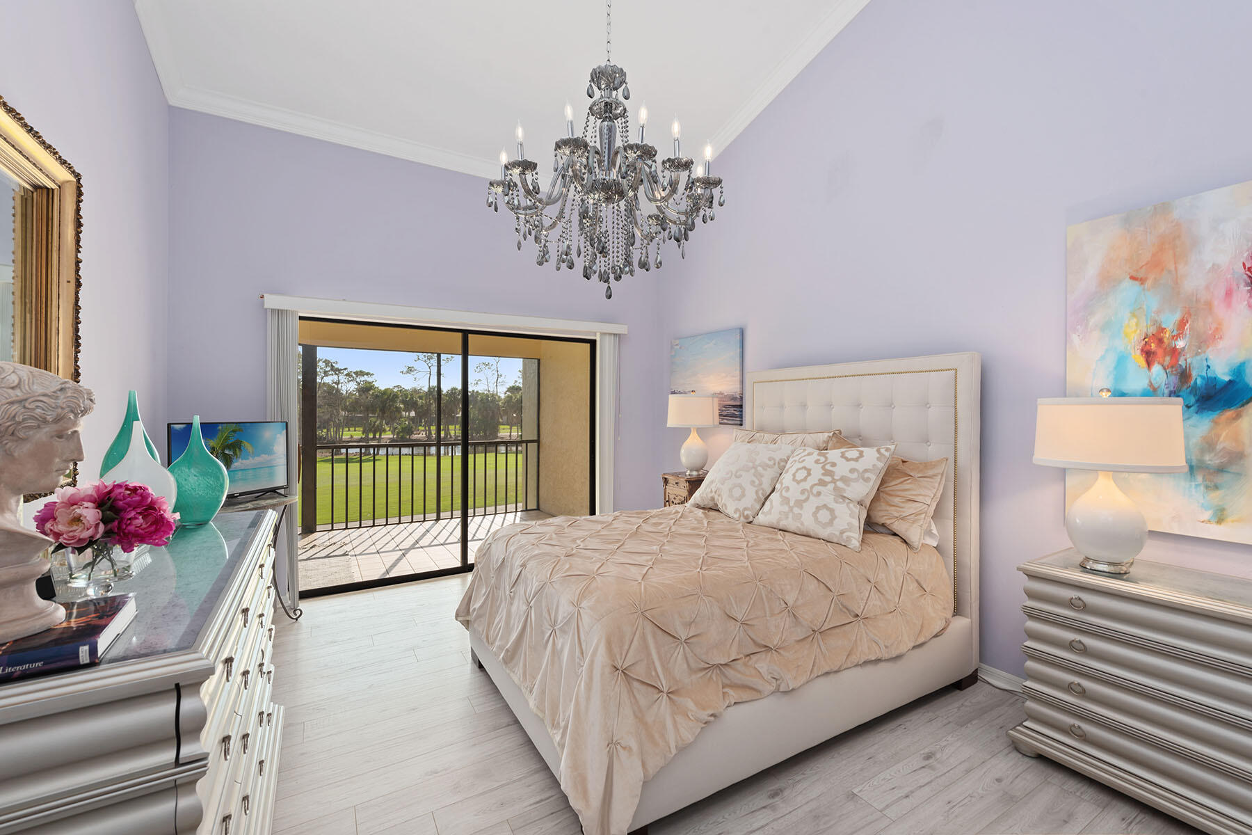 792 Eagle Creek Drive, Unit 204 Naples, FL 34113 - Photo 10 of 49 a bedroom with a large bed and a chandelier