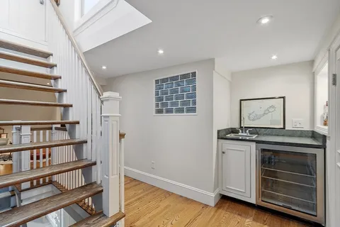 a view of a kitchen with cabinets and wooden floor