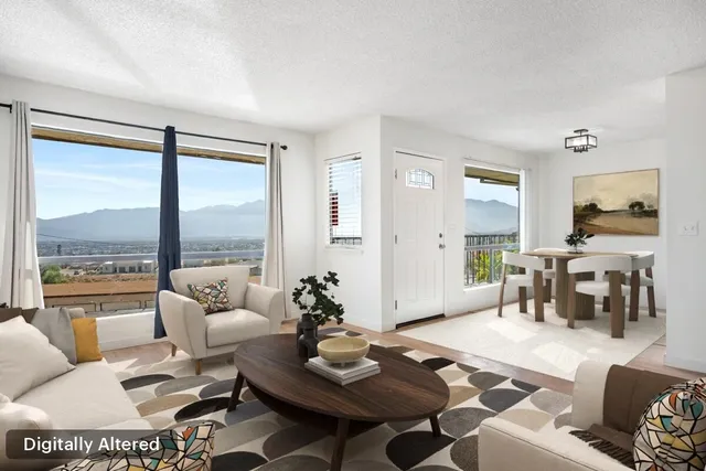 a living room with furniture and a large window