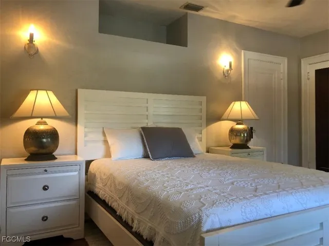 a bedroom with a bed and a mirror